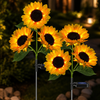 Solar sunflower garden stake light glowing outdoors at night